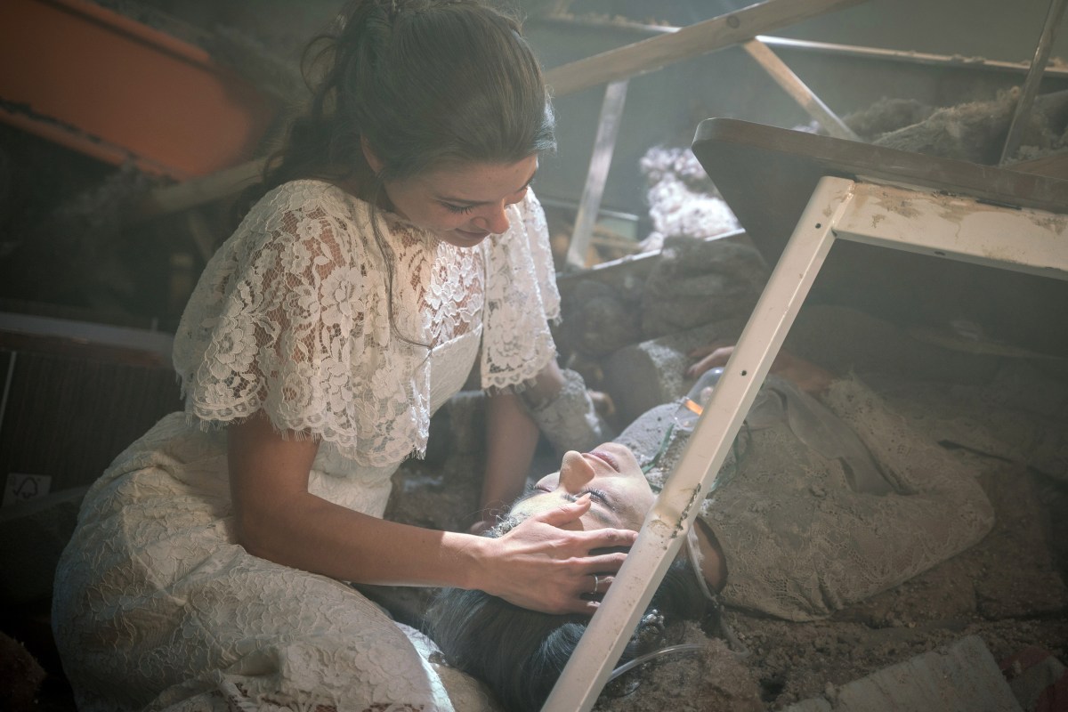 A scene from Coronation Street where Rana Habeeb lies crushed under a collapsed roof while her bride-to-be holds her