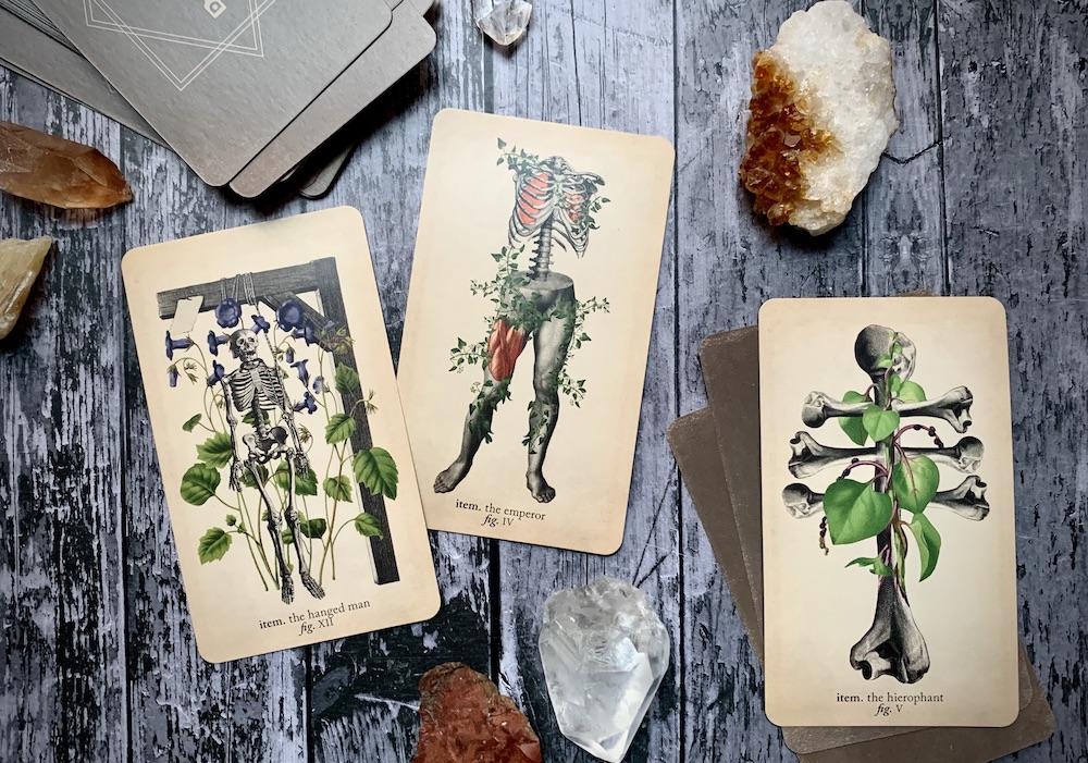 Three cards representing the Hanged Man, the Emperor, and the Hierophant