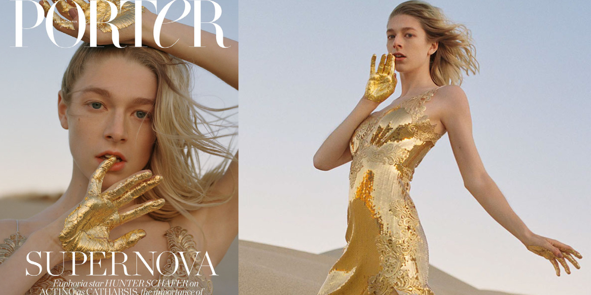 Hunter Schafer has her hands painted gold while wearing a gold spaghetti strapped dress in the desert on the cover of the Net-a-Porter fashion magazine