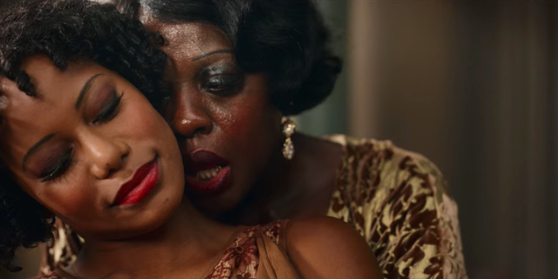 Viola Davis as Ma Rainey stands behind Taylour Paige.