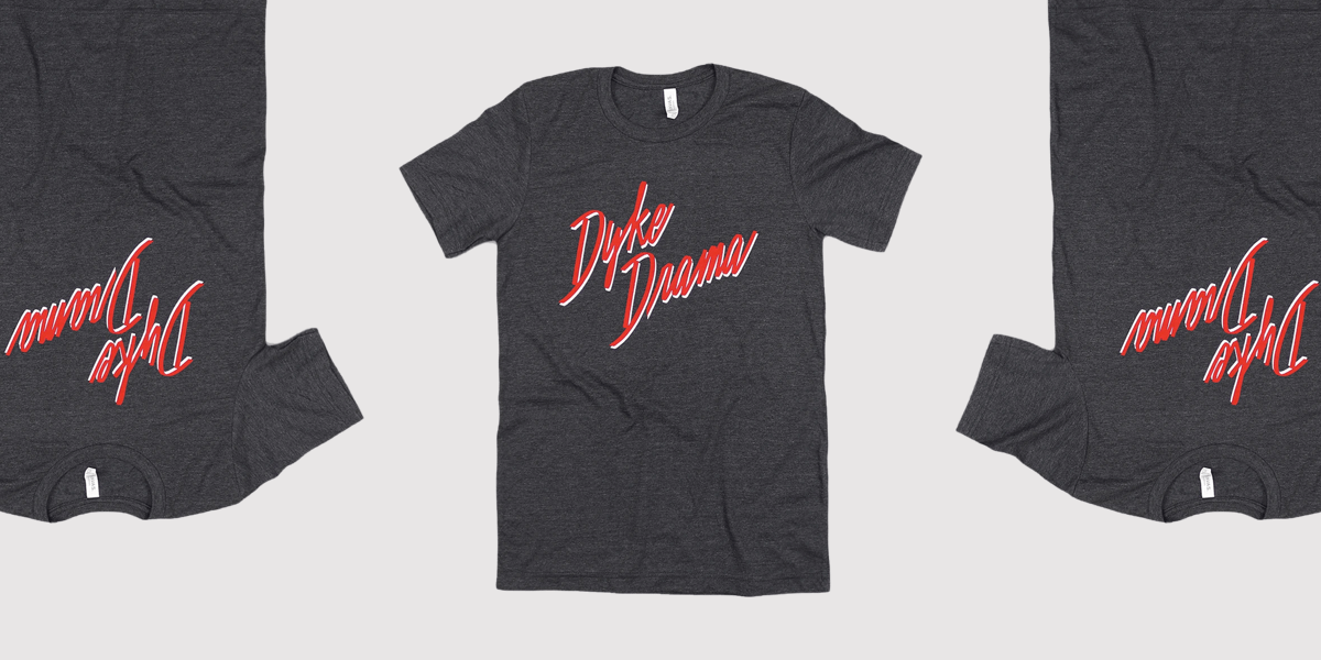 A heather black tee with the words "Dyke Drama" in a scripted, red typeface.