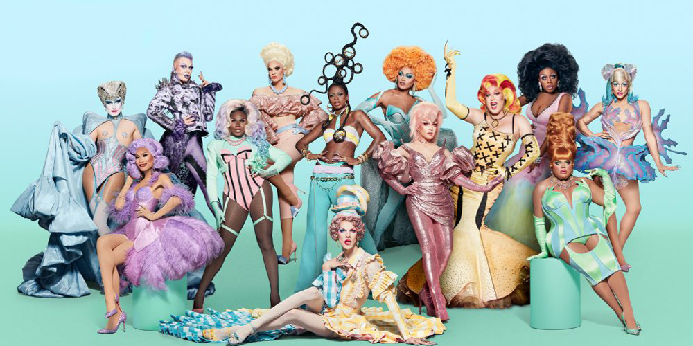 The cast of RuPaul's Drag Race stands together in full costume and wigs against a gradient turquoise blue background. Everyone's too small for noticeable detail, but the image composite makes them all look like pastel colored candies and springtime.