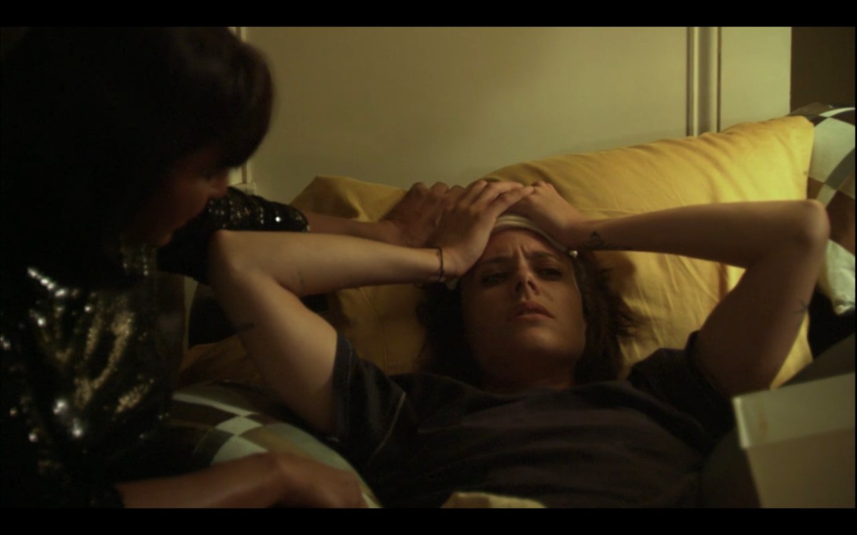 Shane puts her hands on her head in frustration atop Kit's couch