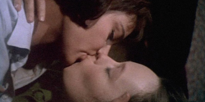 A close up of two women kissing.