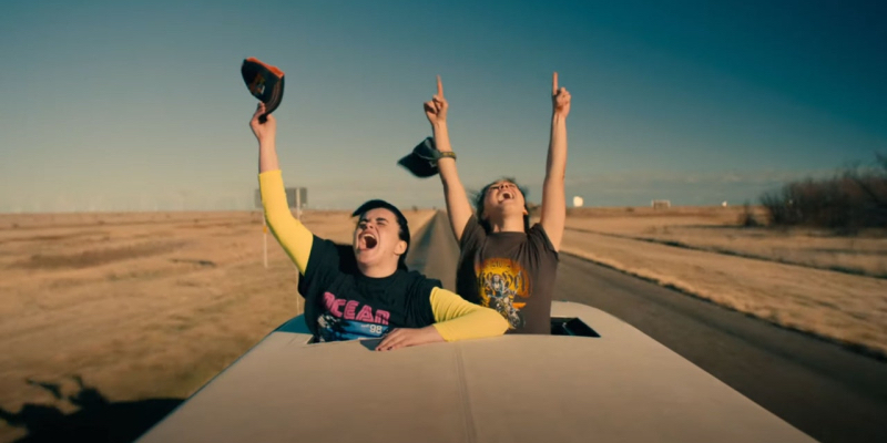Two girls screaming out the top of a car on a desert highway, from Unpregnant.