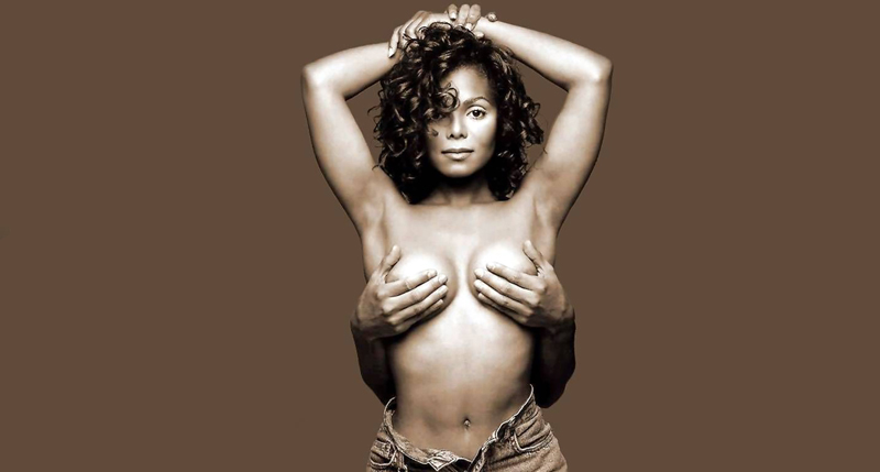 The famous image of Jackson from the cover of Rolling Stone has Jackson topless, with a person holding her breasts in her hands. She is wearing unbuttoned jeans. The photo is against a sepia background.