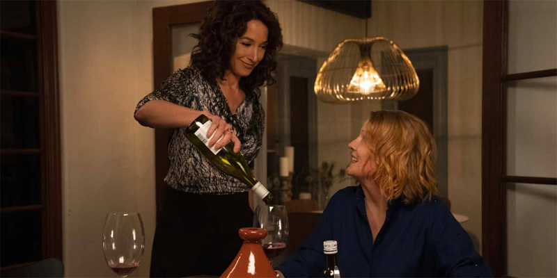 Bette pours Tina a glass of wine in season one of The L Word: Generation Q.