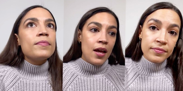 Representative Alexandria Ocasio Cortez is in a grey turtleneck sweater and her long dark brown hair tucked behind her ear on one side.