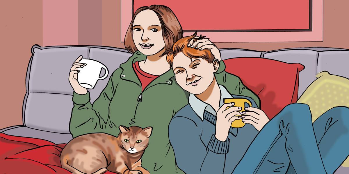 Two humans cuddle on a couch while a cat sits with them.