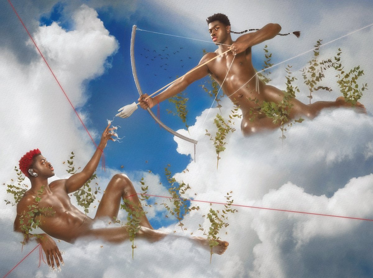 Lil Nas X queer music video promo Image shows two lil nas X's in a reimaging of the "The creation of Adam" by Michelangelo. They are both sitting in the clouds, one reaches out a finger to touch a hand that is on the end of an arrow.