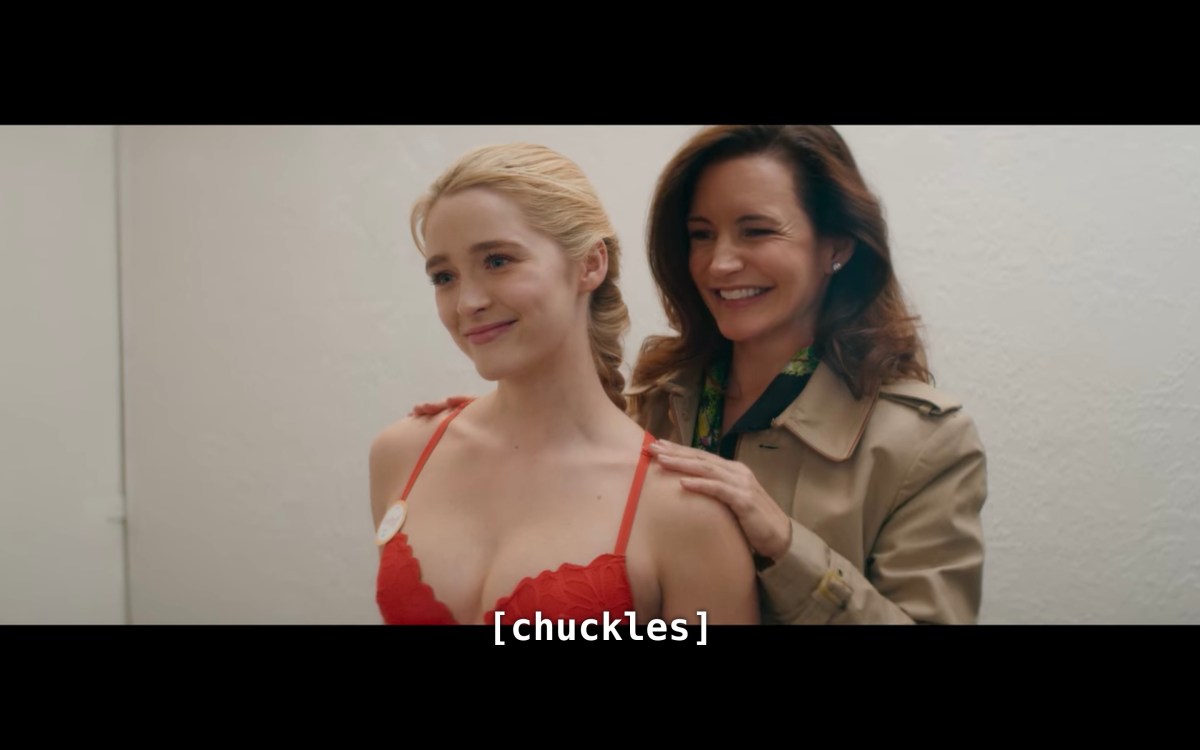 Mary and Grace looking in the mirror of the dressing room, "chuckling"