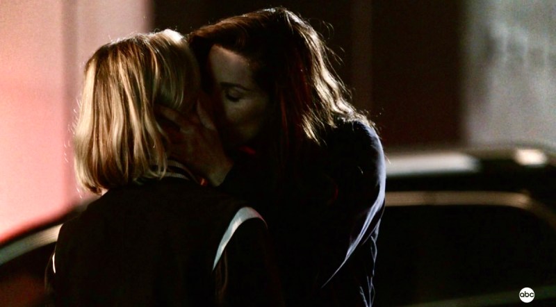 Carina holds Maya's face in her hands and brings her in for a passionate kiss in the nighttime parking lot of Grey Sloan Memorial Hospital