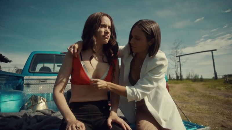 Waverly and Wynonna sit on the edge of the bed of Wynonna's pickup truck, Wynonna looks a little worse for wear as Waverly adjusts Wynonna's...shirt? second bra? so that it covers her better.