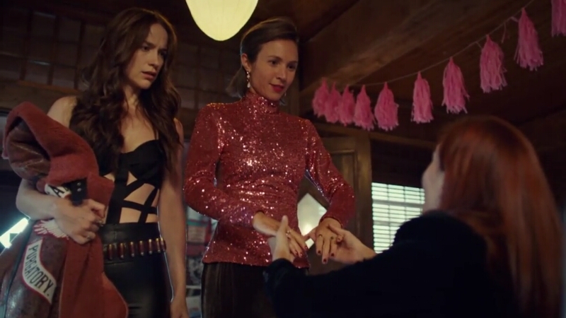 Wynonna is wearing a top that is made almost entirely of straps and Waverly looks pretty in pink as they enter Shorty's. 