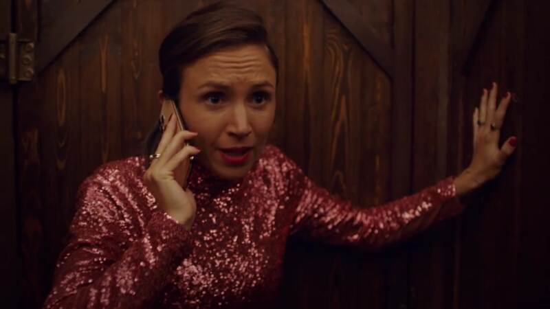 Waverly in her pink sparkly getup hides in a bathroom stall while making a desperate plea into her cell phone.