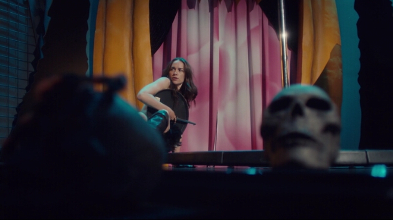 Wynonna Earp is naked on the stage of the Glory Hole covering herself with a waiter tray.