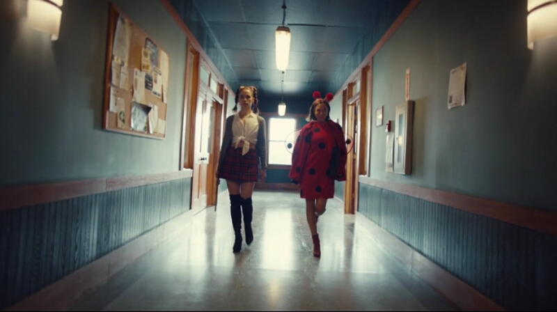 Wynonna and Waverly strut down the hallway dressed as Baby One More Time Britney Spears and a ladybug respectively.