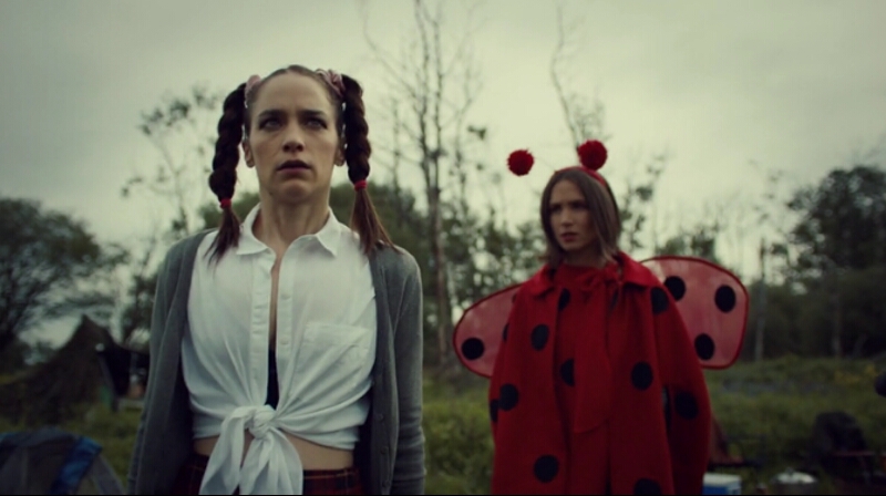 Waverly and Wynonna wear serious expressions that juxtapose their jaunty costumes.