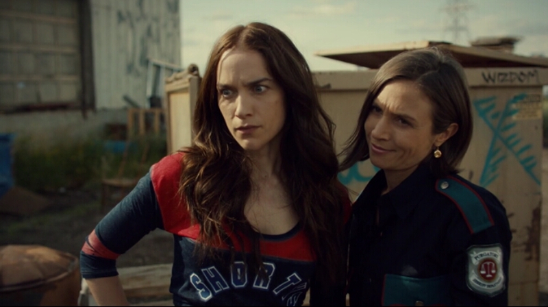 Waverly and Wynonna cling to each other as they look at Amon suspiciously.
