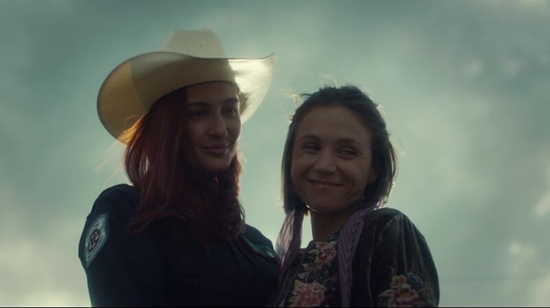 Nciole and Waverly smile happily down at Wynonna.