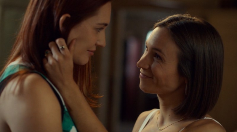 Waverly Earp cradles Nicole's face and looks up at her lovingly
