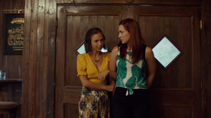 Waverly loops her arm around Nicole's as they enter Shorty's