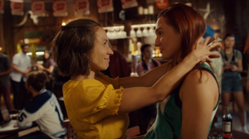 Waverly looks lovingly up at Nicole, her arms around her neck
