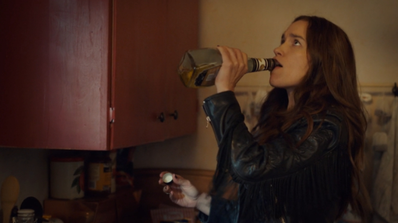 Wynonna takes a swig of banana liqueur