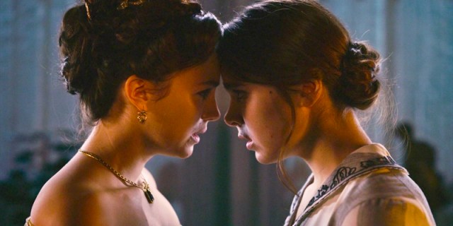 Emily and Sue press their foreheads together in Dickinson season two.