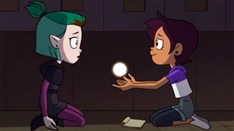 The Owl House screencap: Luz and Amity sit together with a ball of light between them