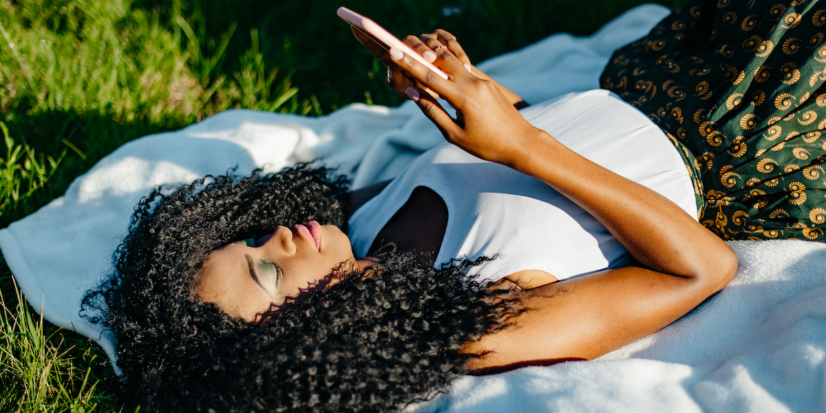 a person reading on a phone outside