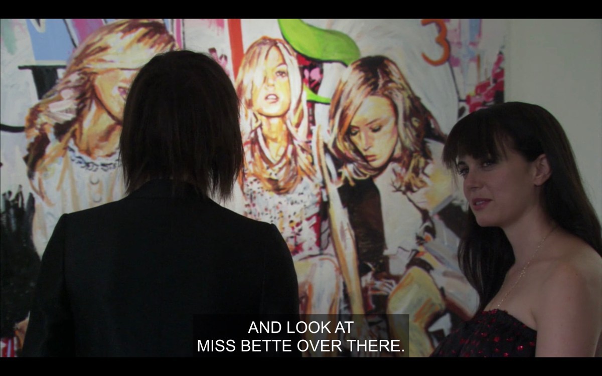 Jenny and Shane in front of a painting of Lindsay Lohan and Paris Hilton