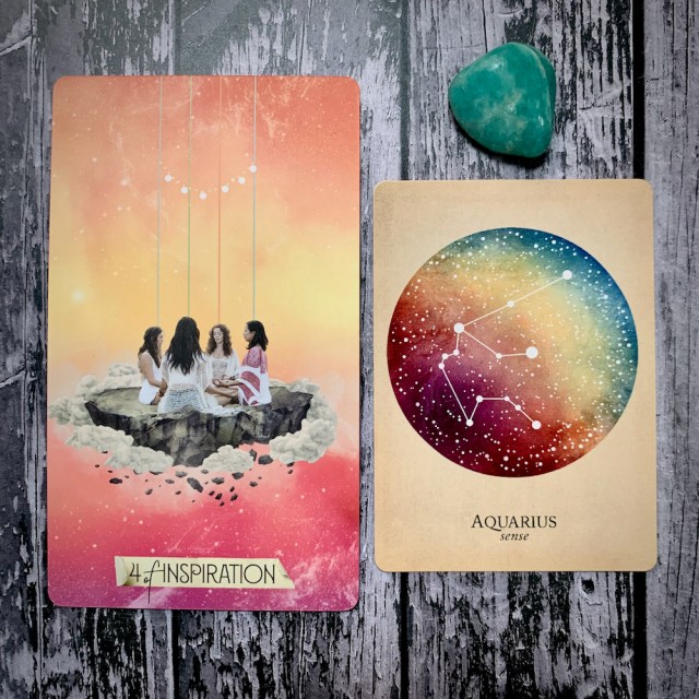 A tarot card for the 4 of Inspiration, featuring four female figures seated on a stone platform clasping hands and meditating or praying; a constellation card reading Aquarius: Sense; and a teal crystal