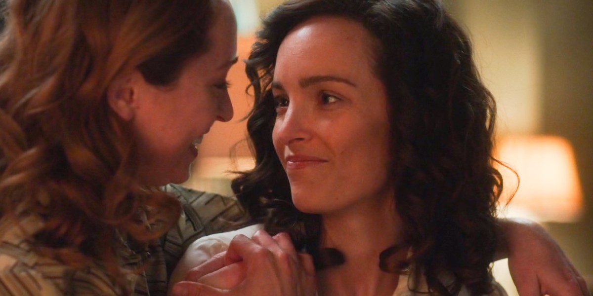 For All Mankind lesbians Ellen looks lovingly at Pam, who has a hand on her shoulder and is returning her smile