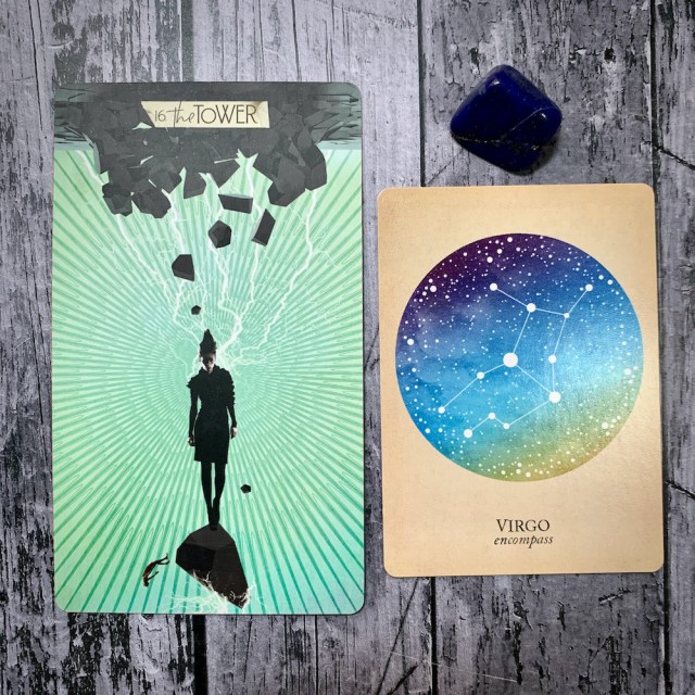 A tarot card for the Tower featuring a figure in black falling through a void with stone and lightning, a constellation card reading Virgo: Encompass; and a blue crystal