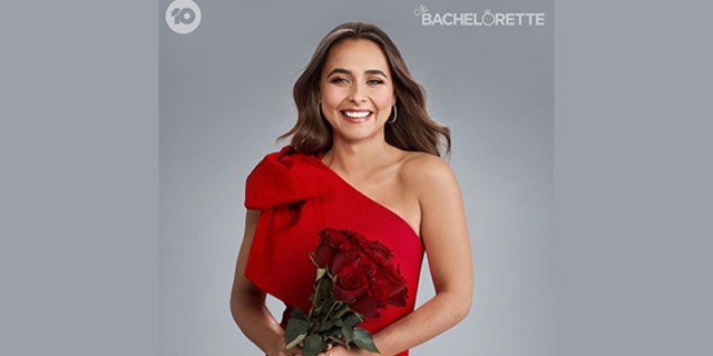 Brooke Blurton, the new bisexual Australian Bachelorette, is in a red dress holding roses against a grey background.