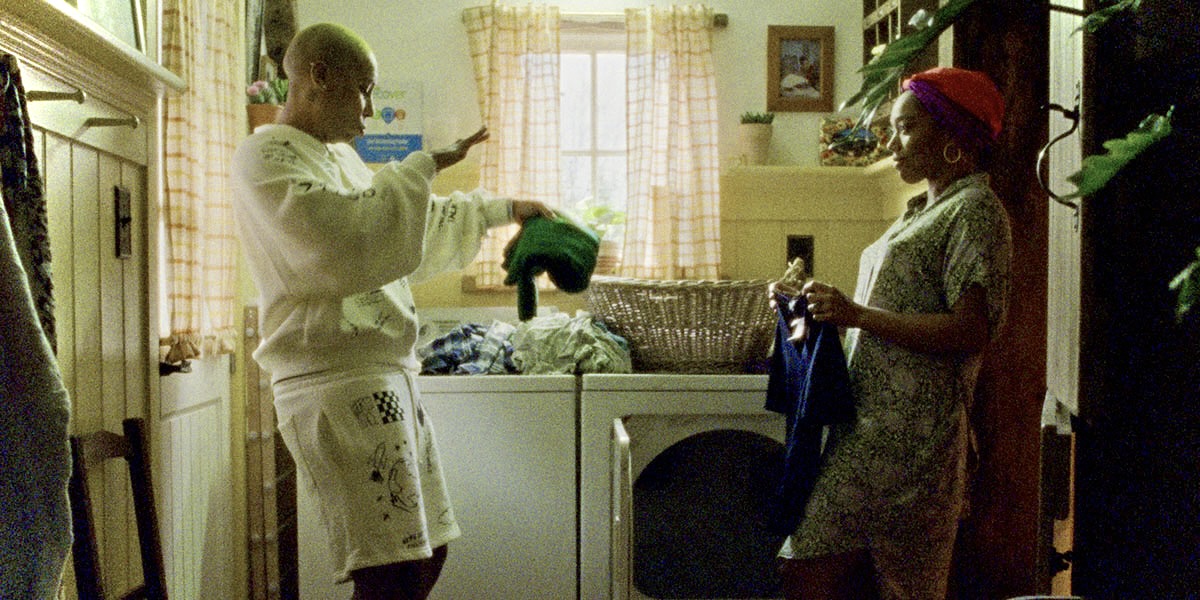 In a still from the third season of Master of None, Lena Waithe's Denise dances while doing laundry with Naomi Ackie's Alicia