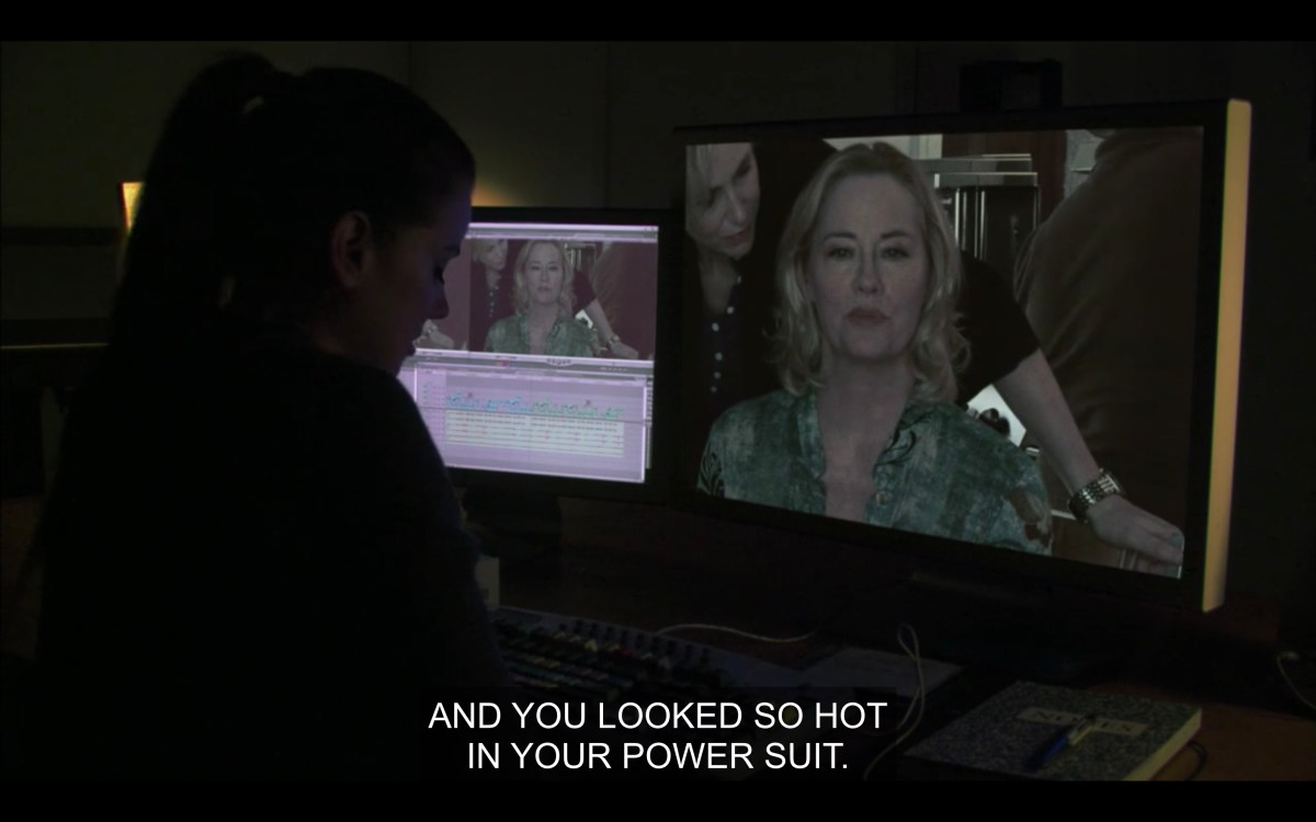 Jenny in the editing bay, Phyllis is on a monitor saying "you looked so hot in your power suit"