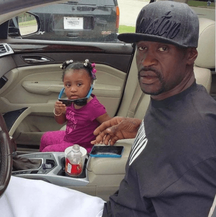 George Floyd sits with his daughter, Gianna, inside of a car.