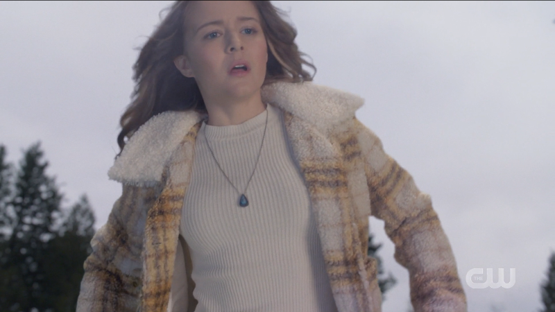 Supergirl episode 606: Young Kara looks surprised while flying in a plaid fleece coat.
