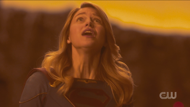 Supergirl Episode 607: Kara looks up with glee into the yellow glow toward her family