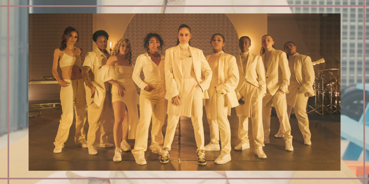 Image Shows Kehlani in her all white suit surrounded by their band who are also all wearing white.