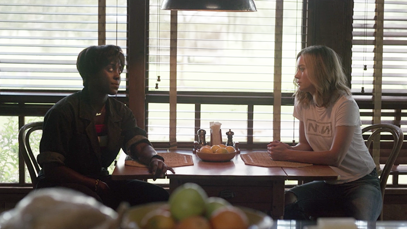 Carol and Maria sit at Maria's kitchen table. 