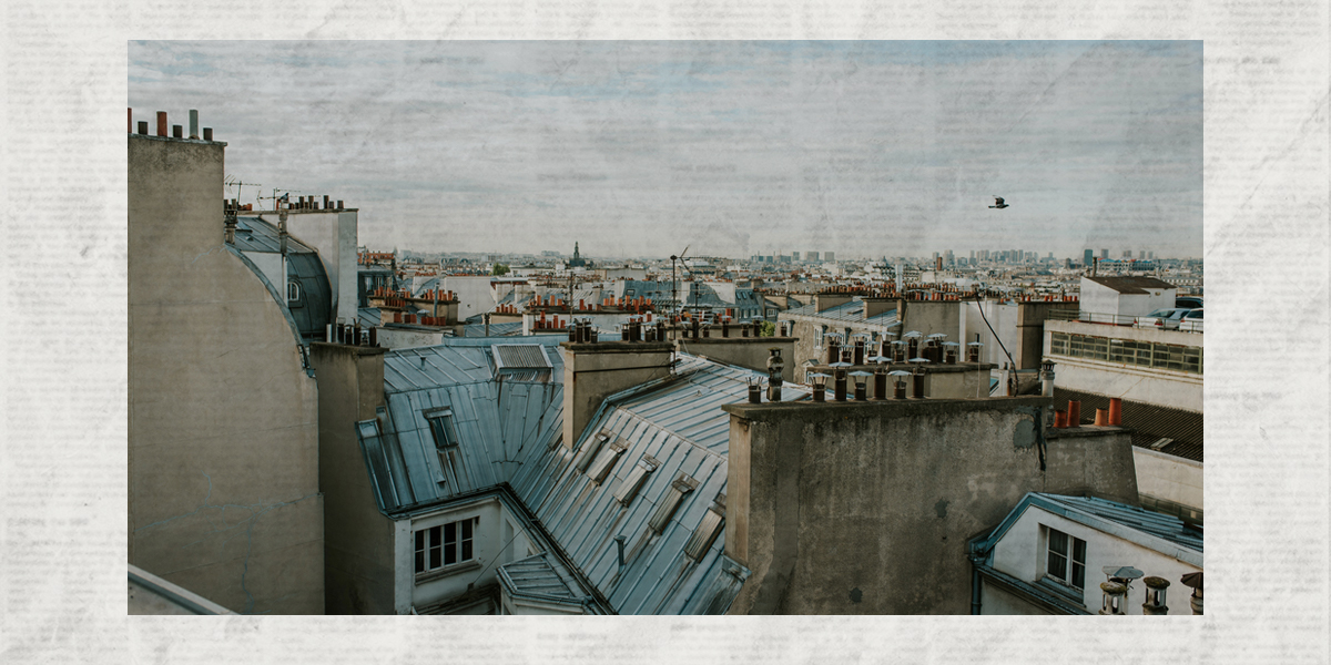 A photo of the rooftops of a Paris neighborhood transposed over a sheet of newsprint