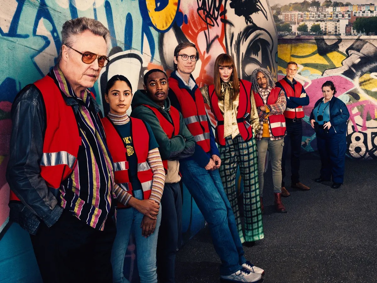 Outlaws cast in their safety vests leaning against the wall