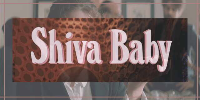 Image shows pink text that reads "Shiva Baby" overlaid on an image of a woman in a black and white suit holding a bagel smeared in cream cheese and smoked meats.
