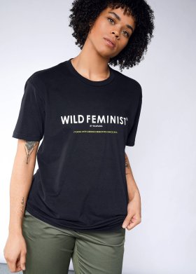 Model in a black t-shirt that says WILD FEMINIST in white lettering.