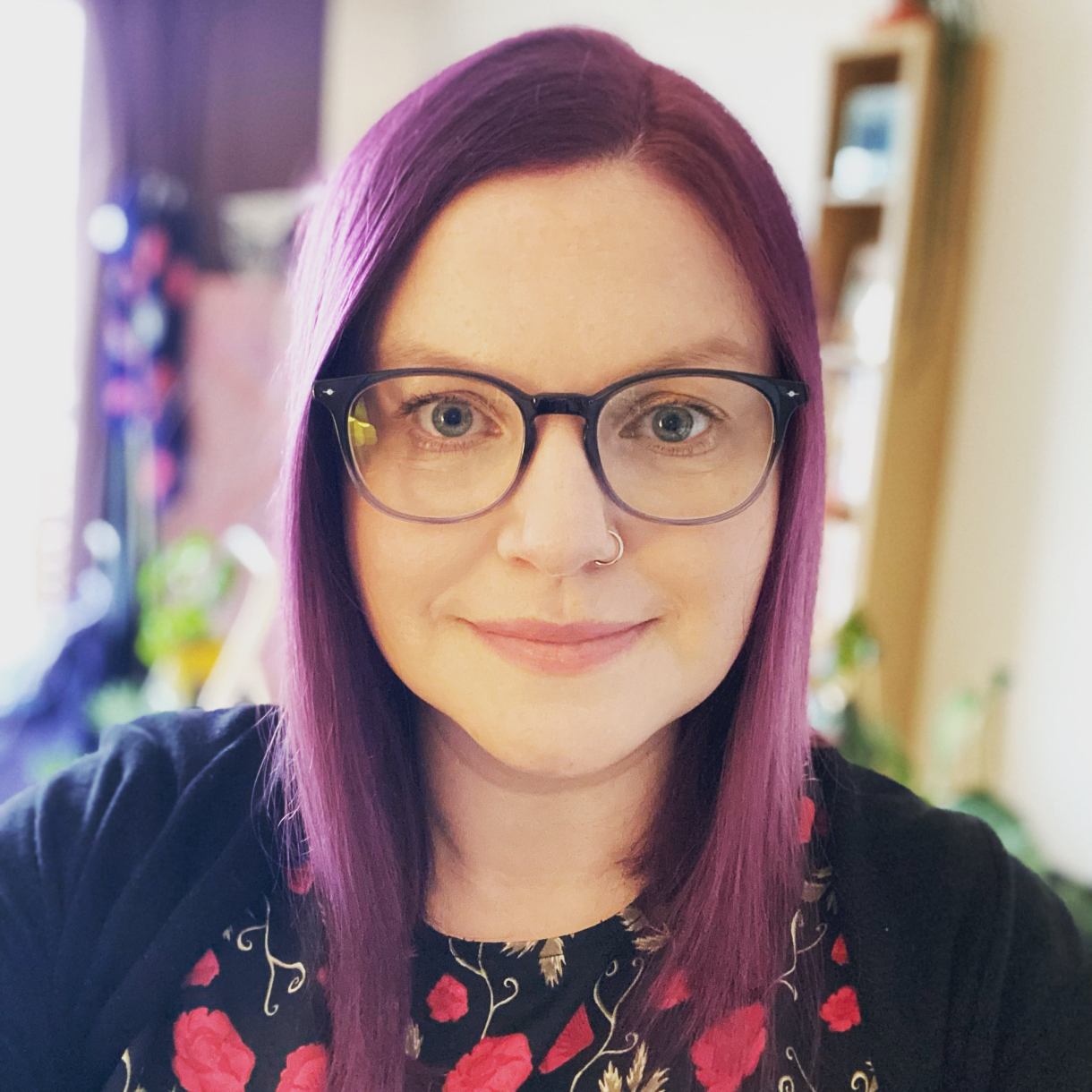 Ellie with purple hair and glasses in Paris