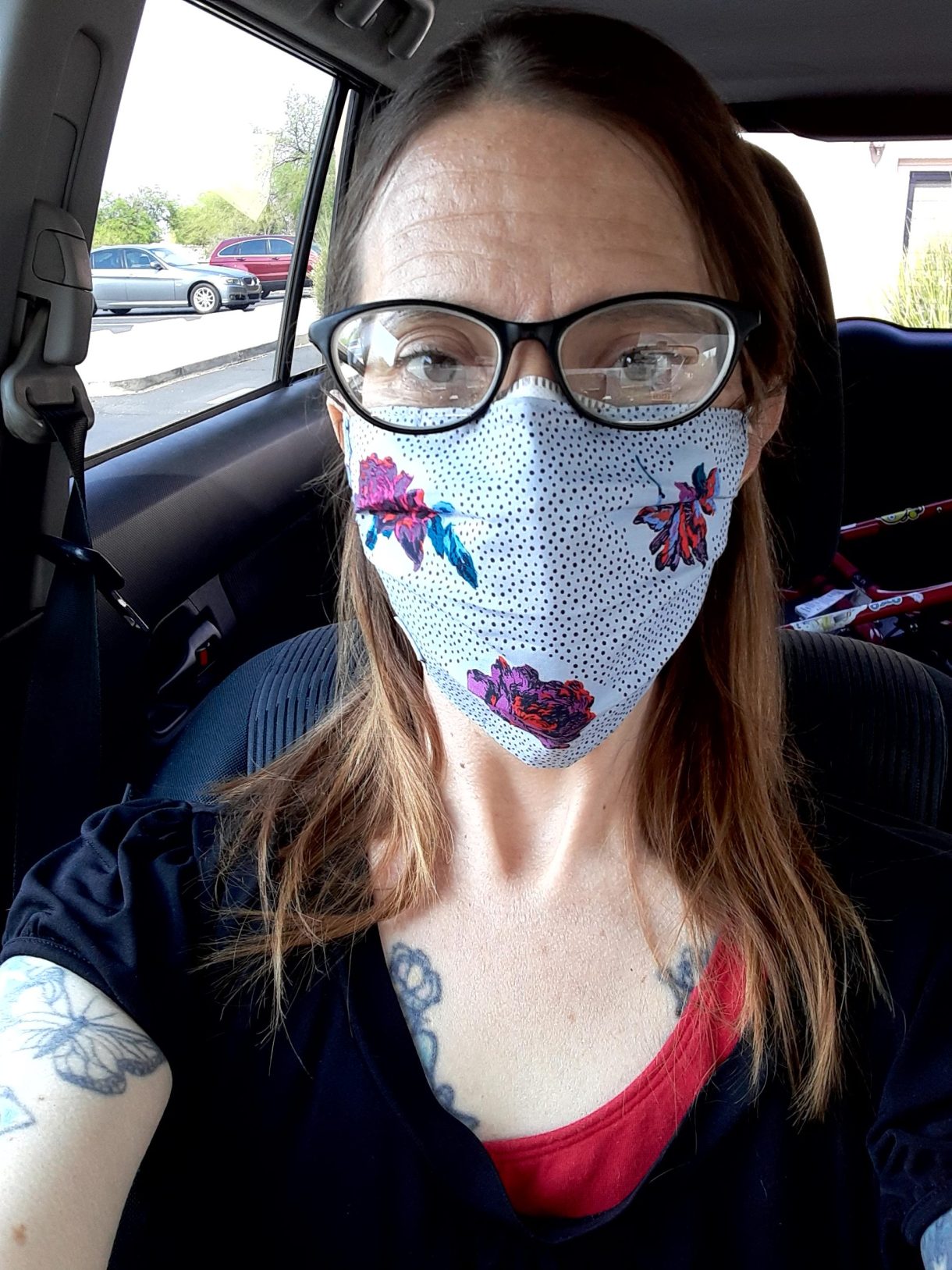 Tracy in a mask in her car