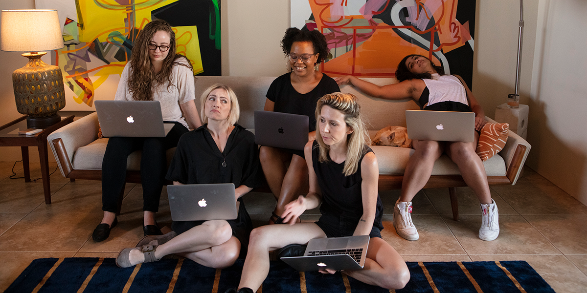 Rachel, Carmen, Sarah, Laneia, and Riese all work on their computers. Sarah is flopping back on the couch.